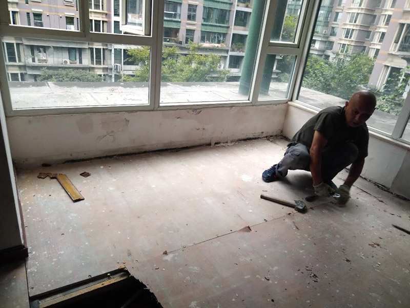 地板拆除維修：復(fù)合木地板拆除工藝比較簡單，清除房間的家具后，使用平口螺絲刀將踢腳線撬開，再沿著踢腳線邊緣將墻角的地板撬開并拆除，這塊地板可能會破損，但是其他地板就可以完整拆除了，帶有鎖扣結(jié)構(gòu)的復(fù)合木地板要順應(yīng)地板的長邊抽出，這樣會比較輕松。拆除后的復(fù)合木地板沒有保留價值，一般都要清運出場最后將鋪至地板下防潮氈揭開，底層可能會有潮濕，這時要開窗通風(fēng)，待地面完全工燥后再鋪設(shè)新地板。 實木地板的拆除工藝比較復(fù)雜，拆除踢腳線后仍從墻角邊緣開始，使用起釘錘將木地板撬起抽出，由于實木地板安裝在木龍骨上，撬起時會有一定的彈性，施工難度較大，但是不能使用切割機，因為切割機容易破壞地面和固定木龍骨的膨脹螺栓而產(chǎn)生火花。