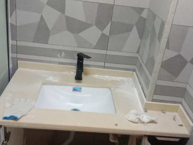 臺盆五金安裝：1.檢查預(yù)留給排水管路，安裝支撐洗面盆臺面的鋼制支架。 2.根據(jù)臺下盆包裝箱內(nèi)的臺面切割圖將臺面開孔打磨完畢。 3.按照安裝的龍頭和臺面尺寸正確切割龍頭安裝孔，打磨。 4.把洗面盆暫時放入已開好的臺面安裝口內(nèi)，檢查間隙，并做好記號。 5.檢查校驗后，把洗面盆放平，在洗臉盆邊緣上口涂上硅膠密封材料后，把洗面盆小心放入臺面下，對準(zhǔn)安裝孔，跟先前的記號相校準(zhǔn)并向上壓緊，并使用廠家隨貨附帶的臉盆與臺面的連接件，將洗臉盆與臺面緊密連接。 6.臺下盆邊緣打膠。 7.安裝臺下盆上下五金件。 8.等密封膠硬化后，連接進水和排水管件。