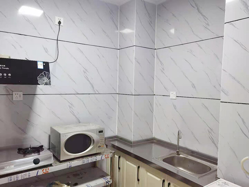 出租房廚房墻貼微晶板：將粘有圖案的轉(zhuǎn)移膜輕輕的撕離圖案的底紙，如果圖案有沒粘在轉(zhuǎn)移膜上的地方，可以用小刀輔助一下。先將轉(zhuǎn)移膜剪下的邊角料挑選個(gè)墻角的墻面測(cè)試一下墻面的性能，確定墻面沒問題后再粘貼。如果墻面掉粉或在撕下轉(zhuǎn)移膜時(shí)會(huì)連同墻面漆一起粘下，請(qǐng)?zhí)幚砗笤龠M(jìn)行粘貼。　貼圖案的時(shí)候，可以先將轉(zhuǎn)移膜的一角先粘在墻上，然后慢慢的將粘有圖案的轉(zhuǎn)移膜順著向下的方向貼在墻上，接著用卡片由圖案中間向四周的方向反復(fù)劃幾下，使墻貼更好粘在墻壁。